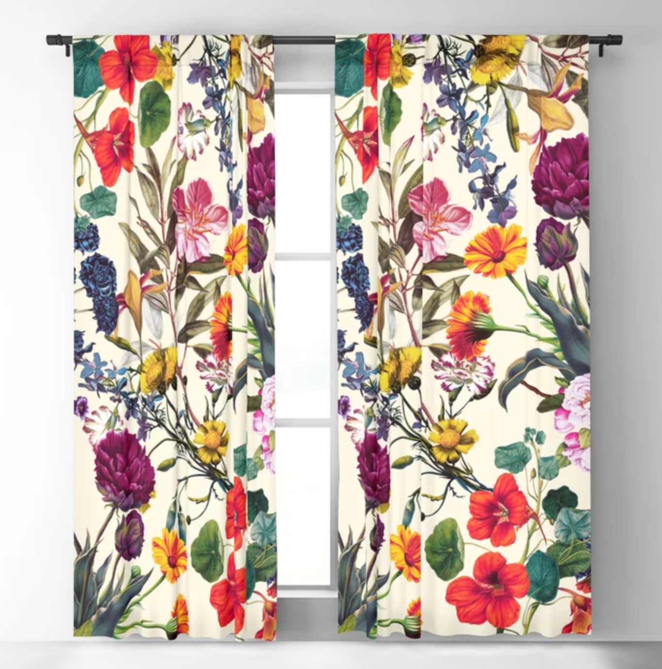 Cream curtains with red, purple, and yellow flowers attached to a window