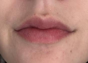 Close-up of a reviewer's aft lips, showing earthy texture and detail, featured successful a buying nonfiction astir articulator attraction products