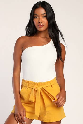 model in yellow tie waist shorts