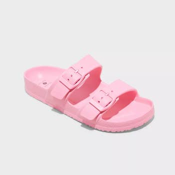 A pair of pink slide sandals with adjustable straps displayed on a plain background