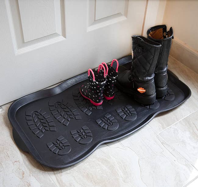 the black boot tray holding two pairs of boots
