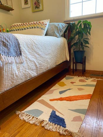 a reviewer's bedroom with rug beside bed