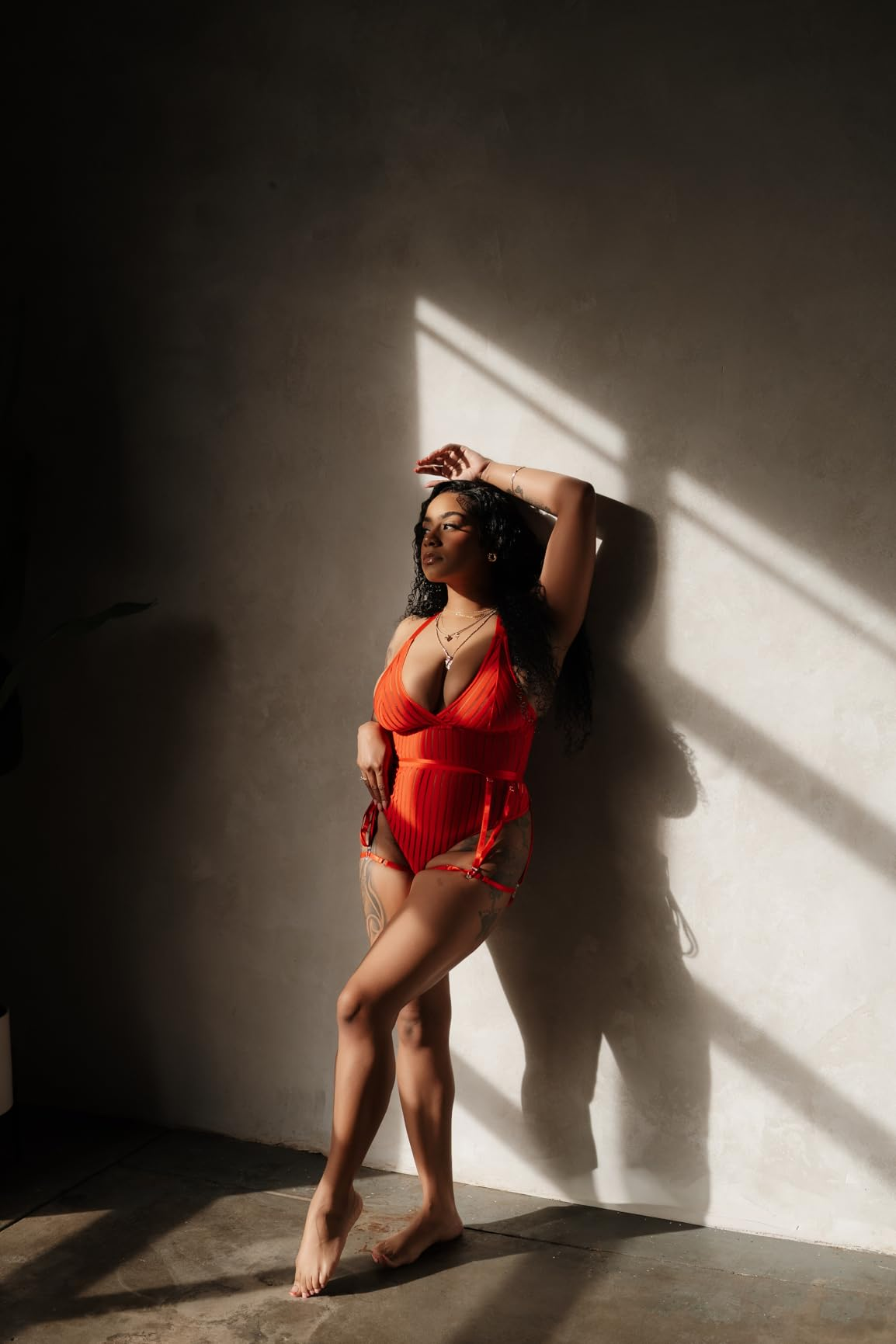Person successful  stylish swimwear poses elegantly against a sunlit wall, showcasing a manner  point  perfect  for beachwear shopping