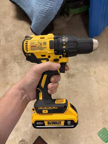 Person holding a DeWalt 20V cordless drill, suitable for DIY and nonrecreational projects