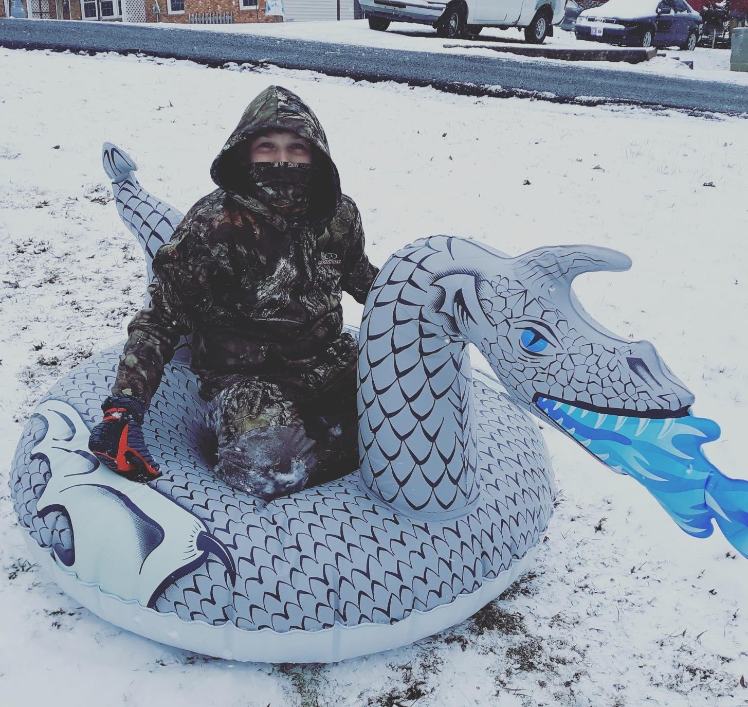 a reviewer on a snow tube that looks like a dragon