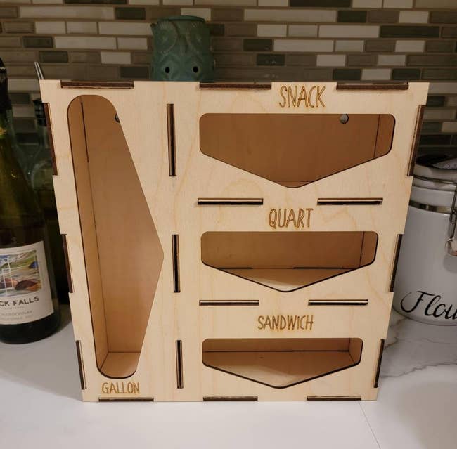 the organizer which has slots for gallon, snack, quart, and sandwich baggies