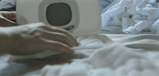 gif of reviewer refilling wipe dispenser with baby wipes