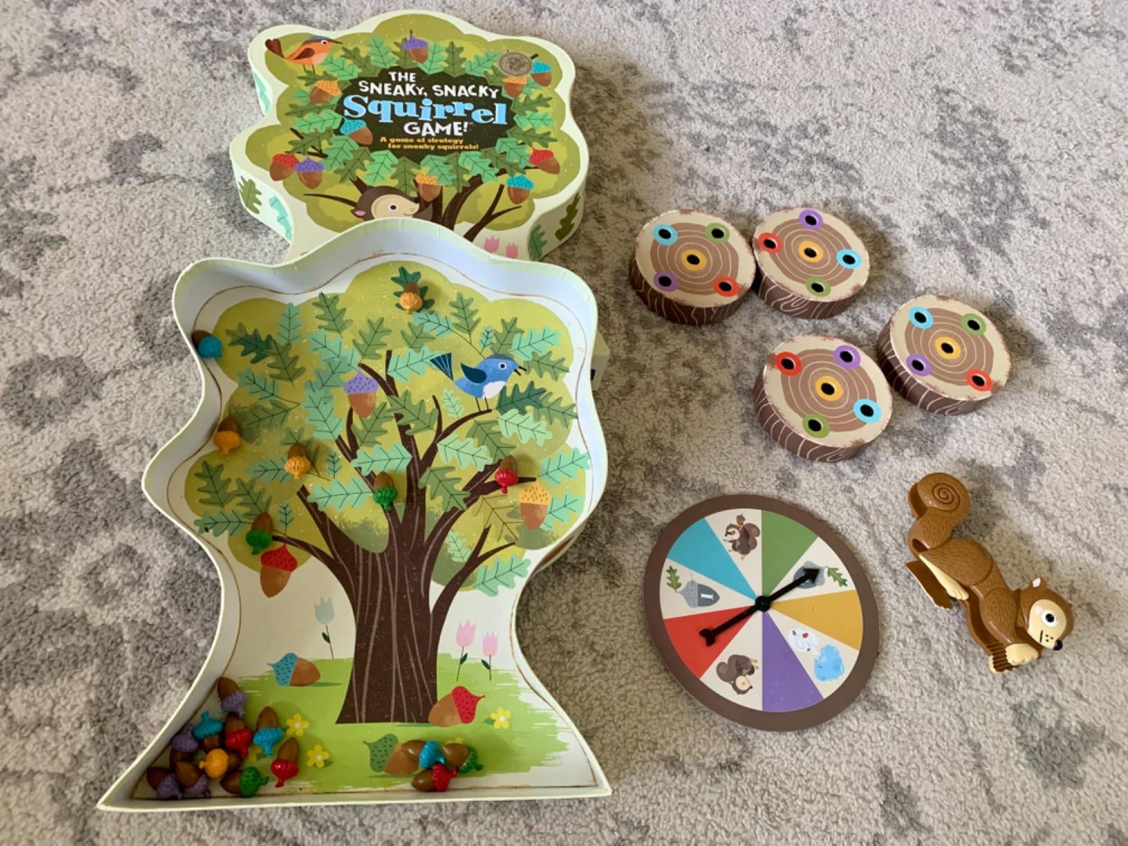 Reviewer image of tree-shaped game board with squirrel, spinner, and tree log pieces