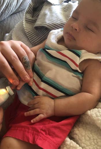 reviewer using the nail trimmer on their baby