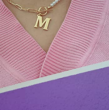 a reviewer wearing the M necklace
