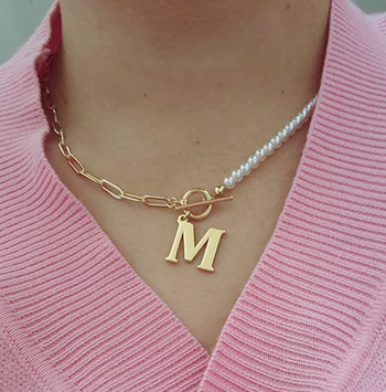 a reviewer wearing the M necklace