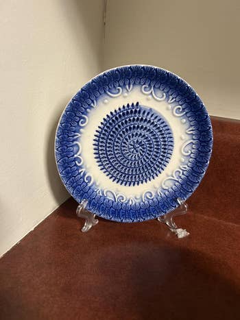 Decorative ceramic sheet with intricate raised floral patterns connected show stand