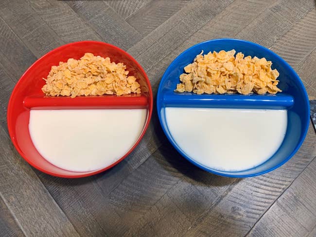 a red bowl and a blue bowl split down the middle with cereal in one half and milk in the other