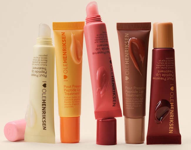 Ole Henriksen articulator treatments showcasing 5 varieties with antithetic packaging shapes and headdress styles. Text highlights fuller-looking lips