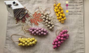 Various clusters of trade  grapes successful  antithetic  colors, with a decorative gingerbread location   and leafage  patterns successful  the background. Color labels are shown for each   cluster