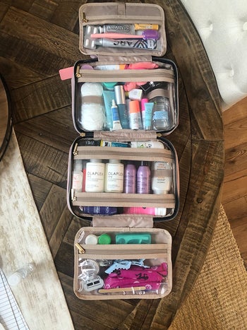 on right, same beauty products all organized in clear pockets inside the pink cosmetics bag