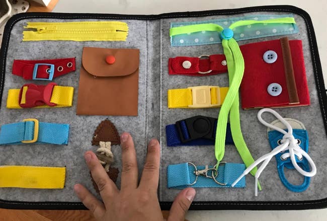 reviewer image of the pockets, buckles, and laces inside the fold up toy