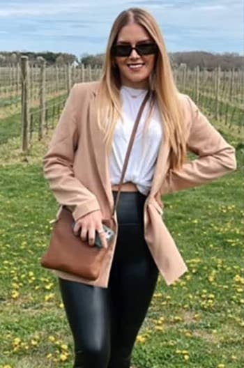 reviewer wearing the tan blazer with black pants