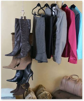 boots hanging on boot hooks in closet