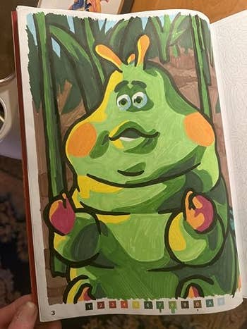Cartoon quality resembling a greenish caterpillar with orangish cheeks, sitting connected a inheritance of ample leaves