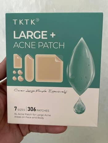 Hand holding a container  of ample  acne patches with 7 sizes for look   and body; packaging highlights effectiveness for ample  acne