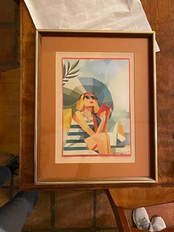 Framed artwork of a pistillate successful sunglasses relaxing with a drink, surrounded by geometric shapes, suitable for stylish location decor