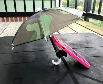 a camo umbrella stuck to the back of a phone