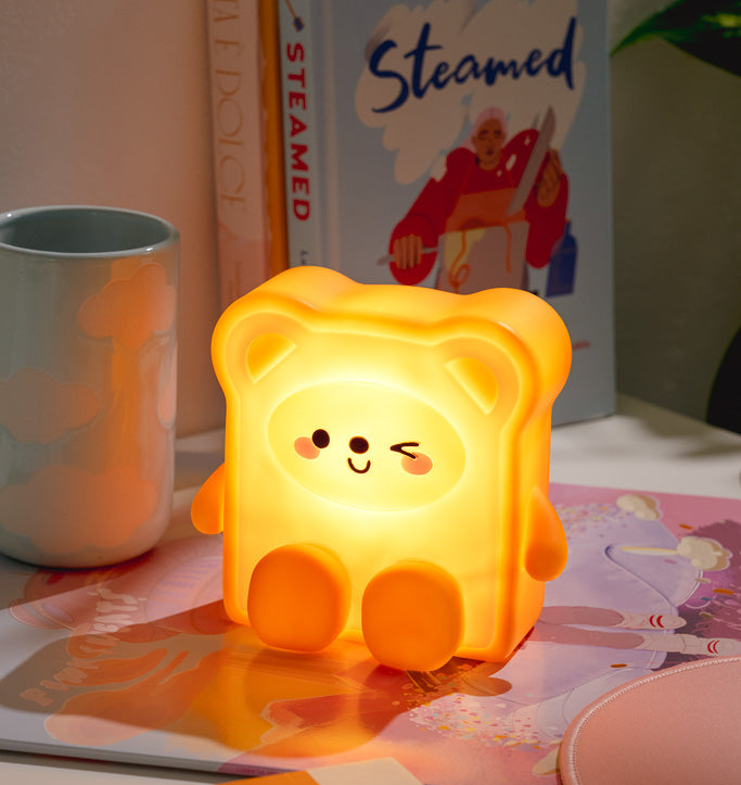 toast shaped light with arms legs and bear ears and face