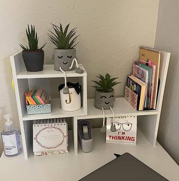 another reviewer's white adjustable desk shelves organizing items