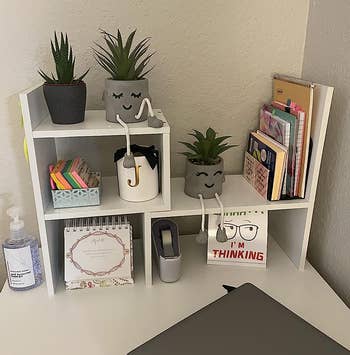 another reviewer's white adjustable desk shelves organizing items