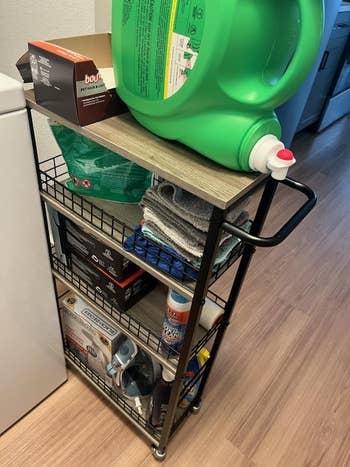 same reviewer showing cart pulled out, revealing each it tin hold