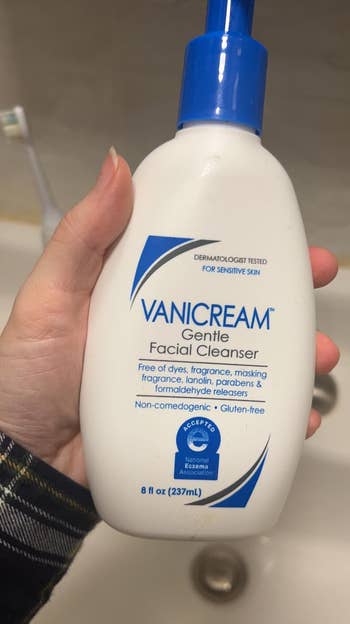 reviewer holding bottle of Vanicream gentle facial cleanser