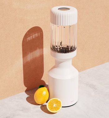 A white blender with a transparent glass top 