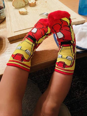 a reviewer's child wearing iron man socks