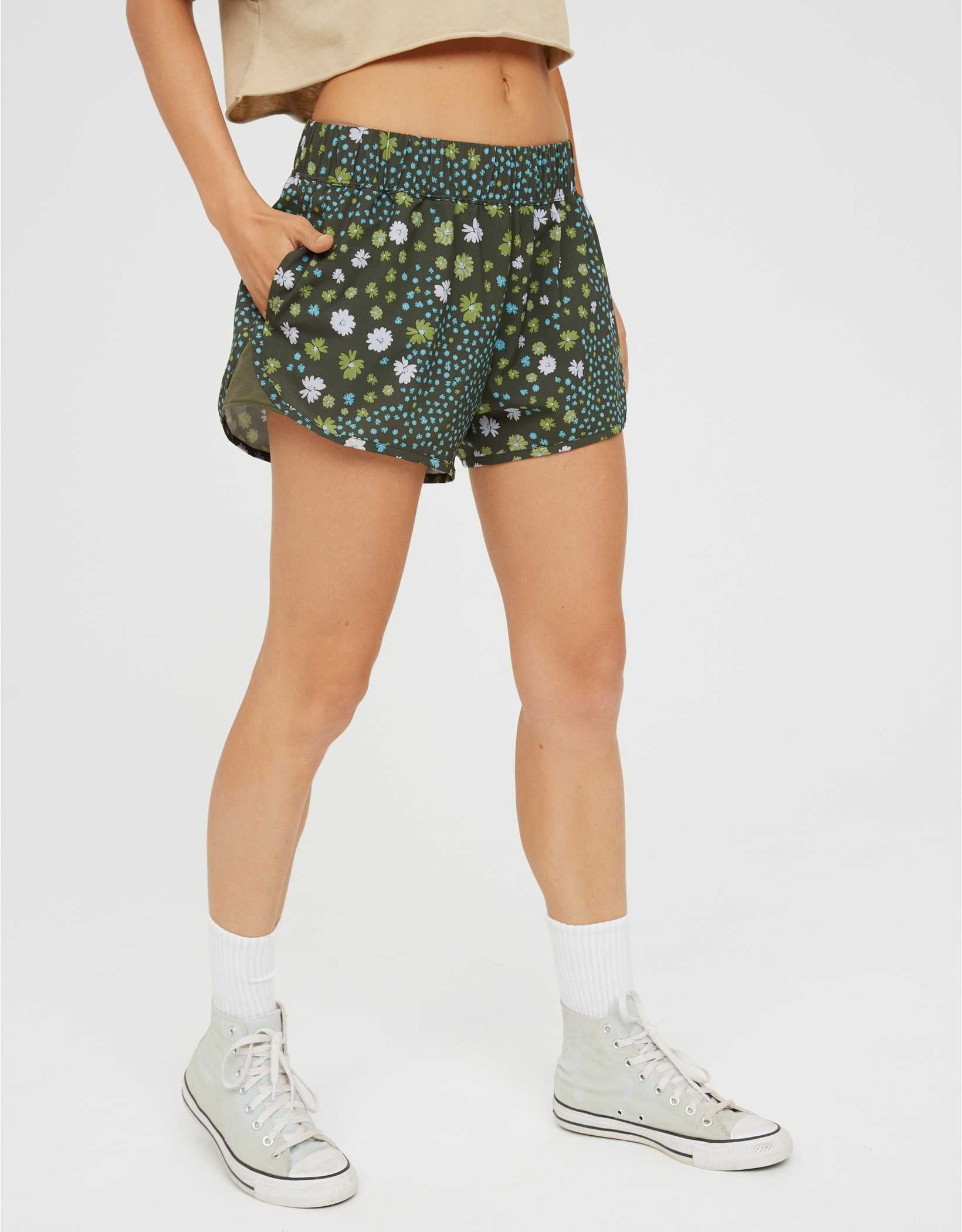 model wearing the shorts in green floral