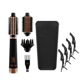 Hair styling tools including a volumizing brush, interchangeable heads, and hair clips on a plain background