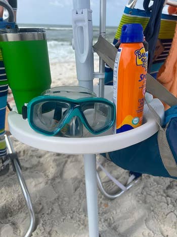 Beach chair tray with snorkeling goggles and sunscreen