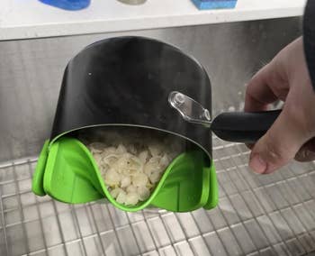 Pot with greenish spout draining pasta into sink