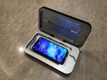 Reviewer photo of the sanitizer with a phone in it