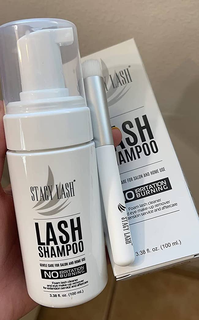 reviewer holding bottle of lash shampoo