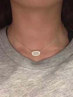 reviewer photo of them wearing a necklace with a sparkly white pendant 