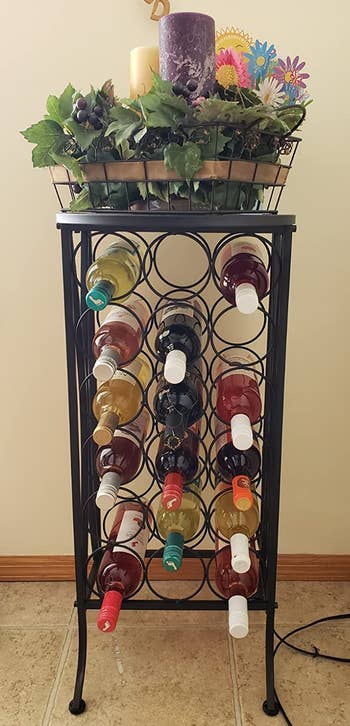Reviewer image of smaller black wine stand with wine bottles