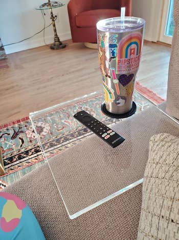 Tumbler with colorful stickers and straw connected  a array  with a distant    control