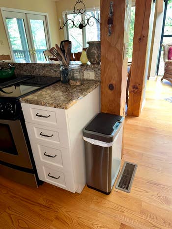 Modern kitchen with a stainless steel trash bin