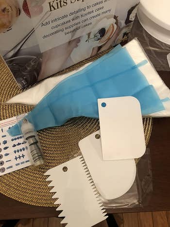 Cake decorating kit with piping bags, icing tips, and scrapers on display