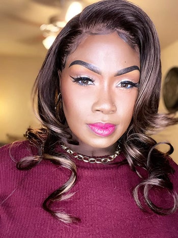 a reviewer wearing a full face of makeup