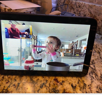 reviewer photo of Amazon Alexa, on video call with baby grandchild