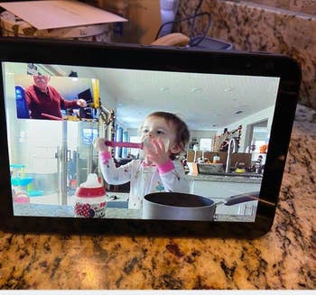 reviewer photo of Amazon Alexa, on video call with baby grandchild