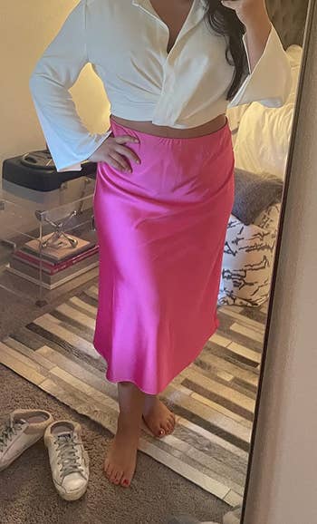 reviewer wearing the skirt in bright pink