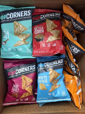Various flavors of PopCorners snack bags, including Sea Salt, Kettle Corn, Sweet Chili, and White Cheddar, displayed successful  an unfastened  box